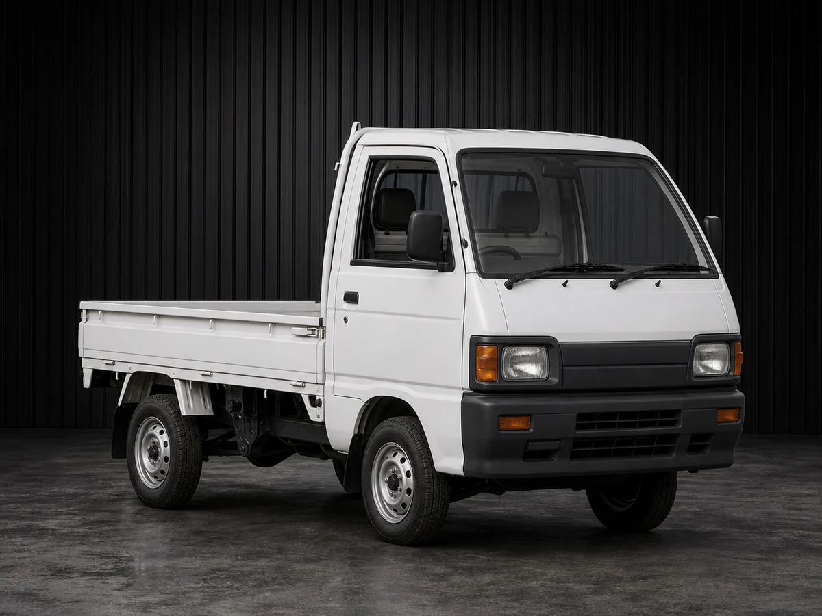 Early-1990s Daihatsu Hijet S83P-era 4WD kei truck in a dark grooved-wall studio