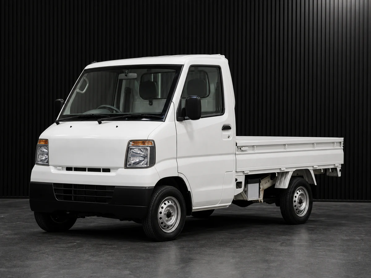 Mitsubishi Minicab U62T-era 4WD kei truck in a dark grooved-wall studio