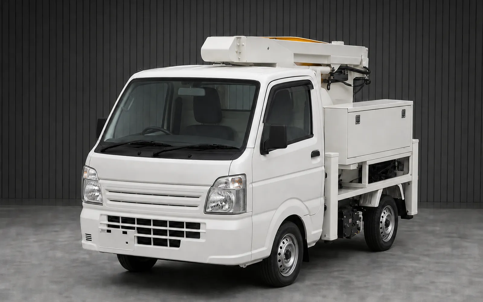 Kei bucket truck with folded aerial work platform boom and stabilizing outriggers