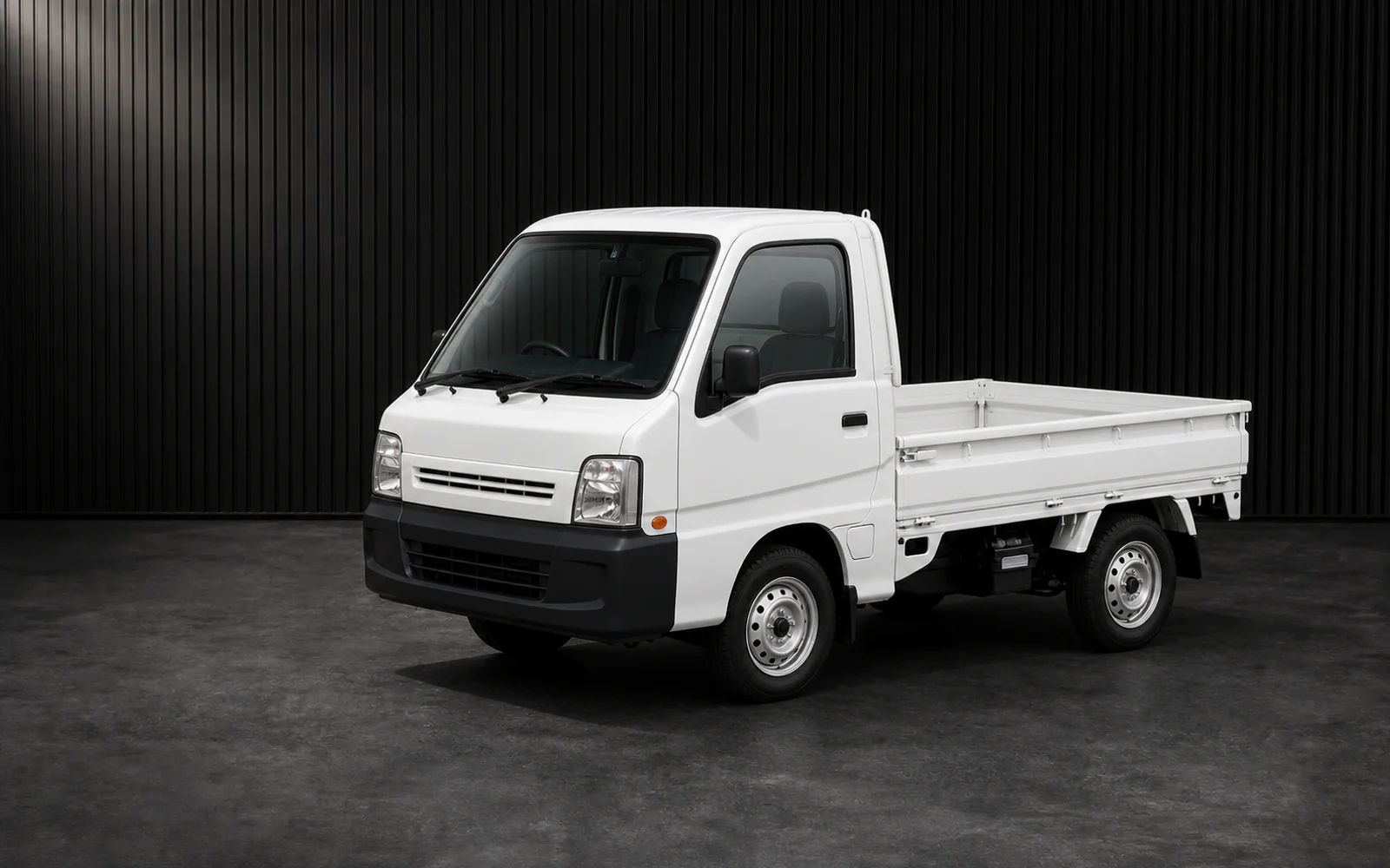 Late Subaru-built Sambar TT2 kei truck in a dark grooved-wall studio