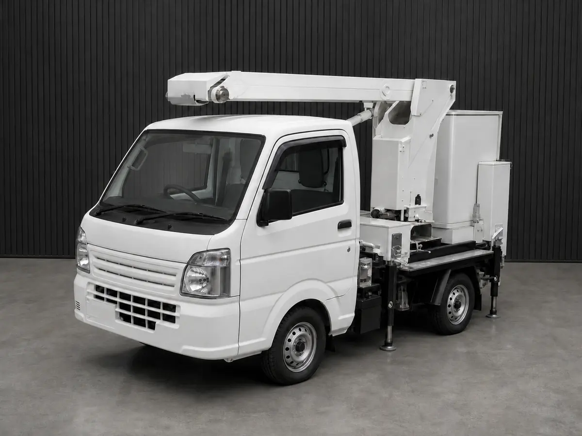 Front three-quarter view of a kei bucket truck with folded boom and outriggers