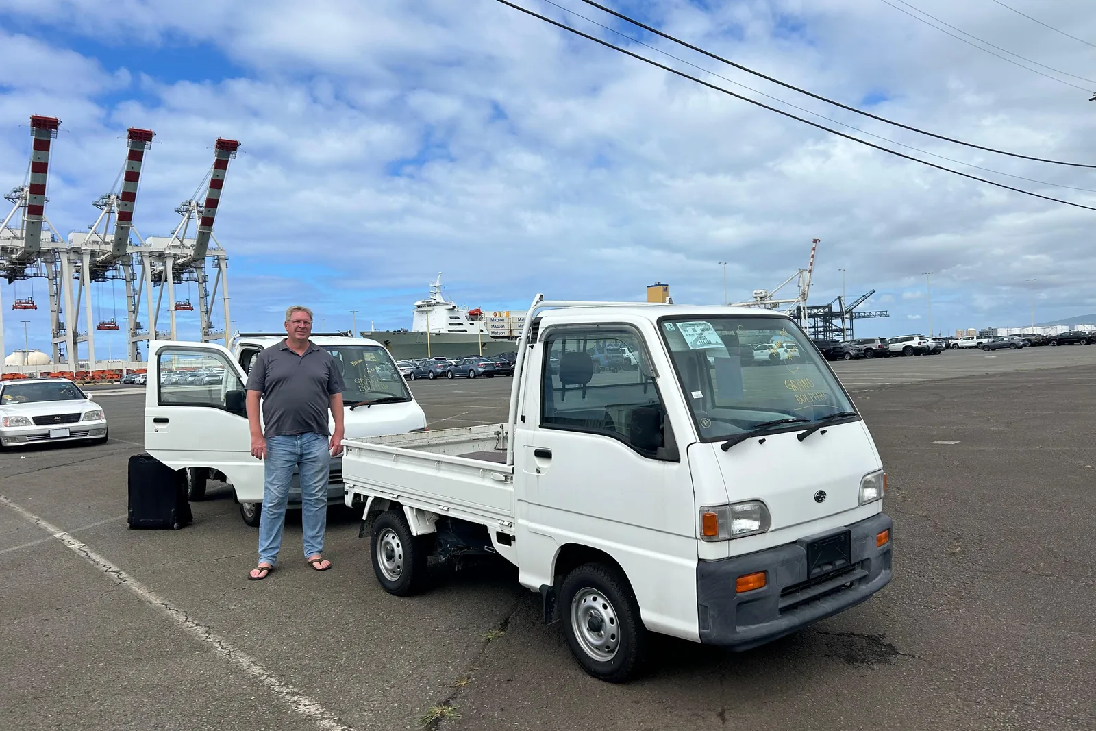 Joseph with his two kei trucks from Mirai Trading at the port in Hawaii