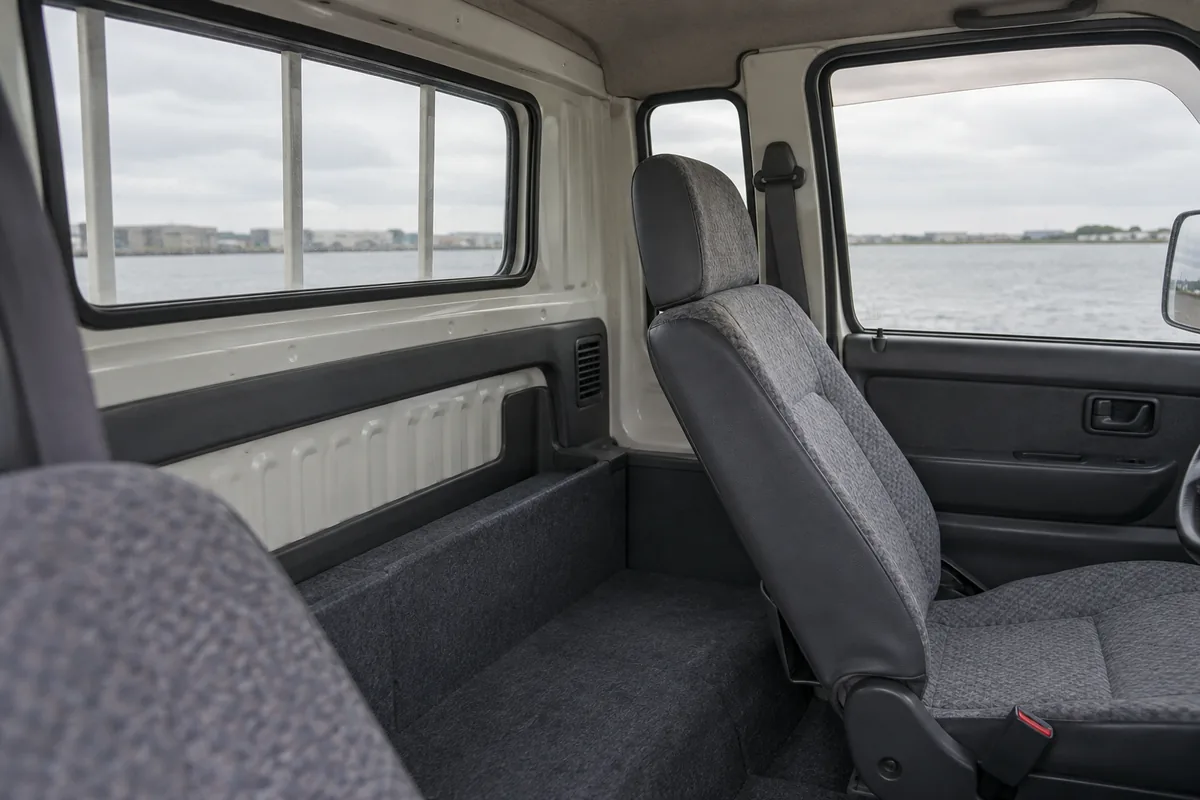 Extra space behind a reclined seat in an extended kei truck cab
